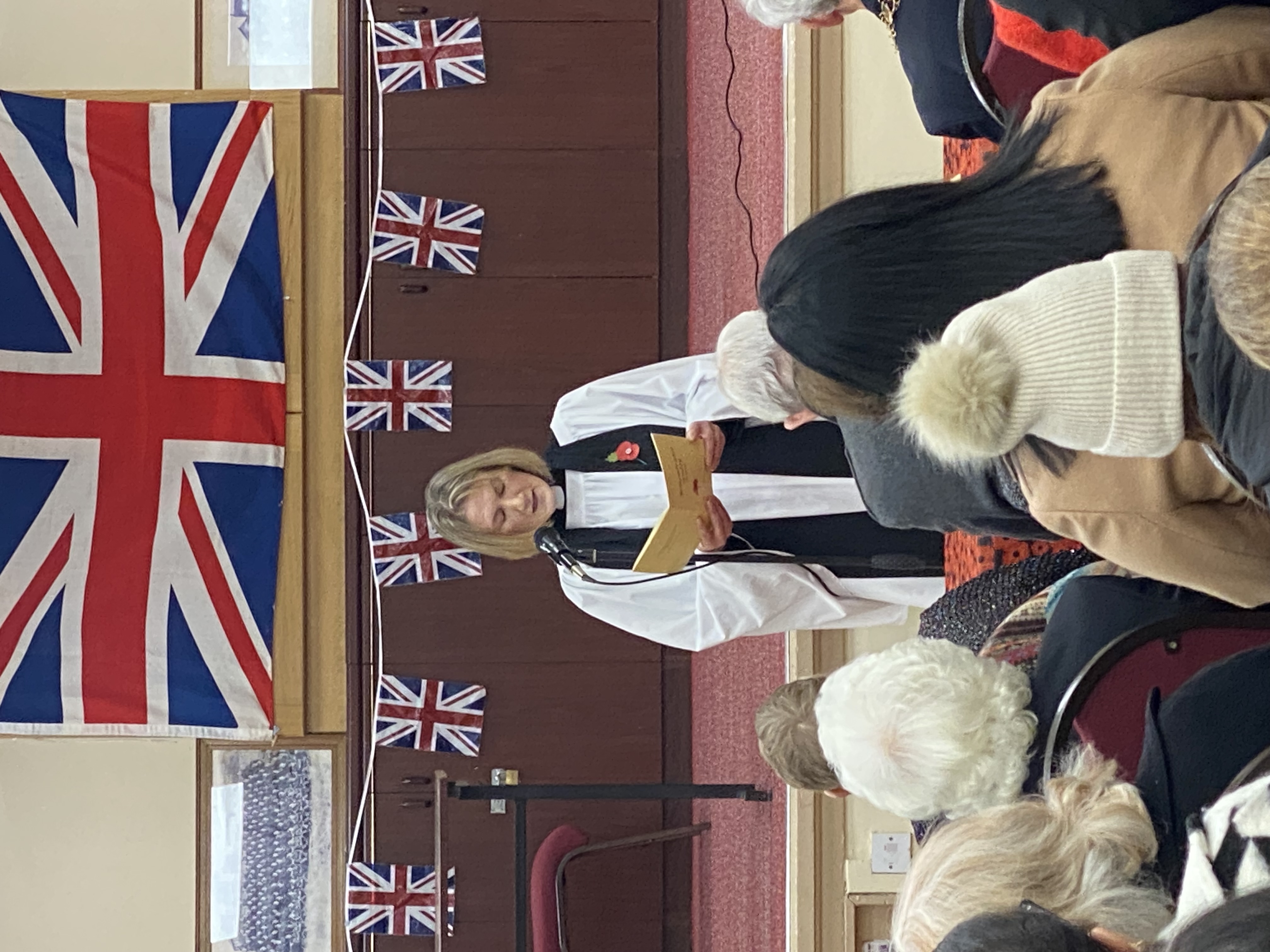 Vicar conducting remembrance day service.