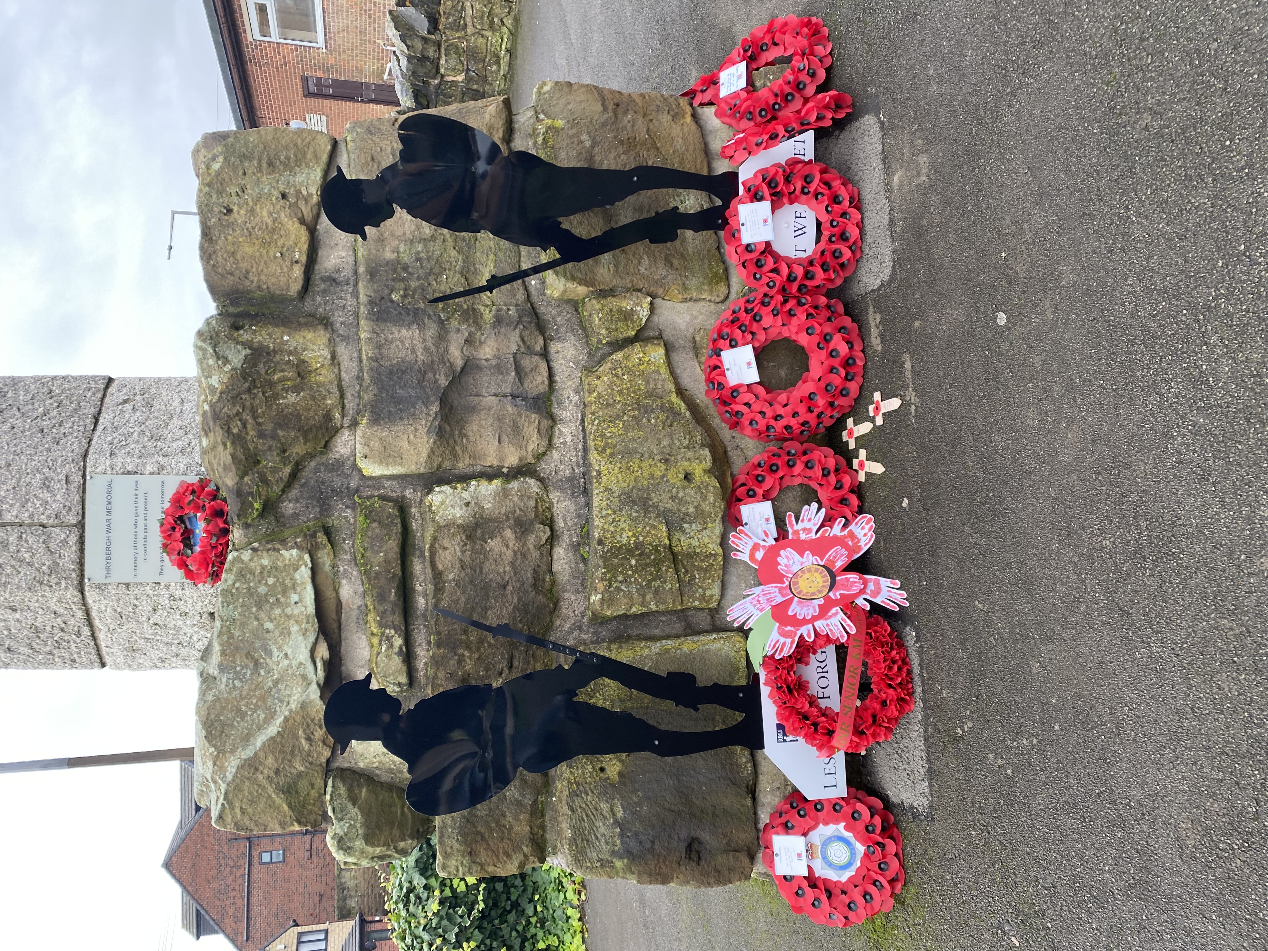 Wreaths laying at the base of war memorial.