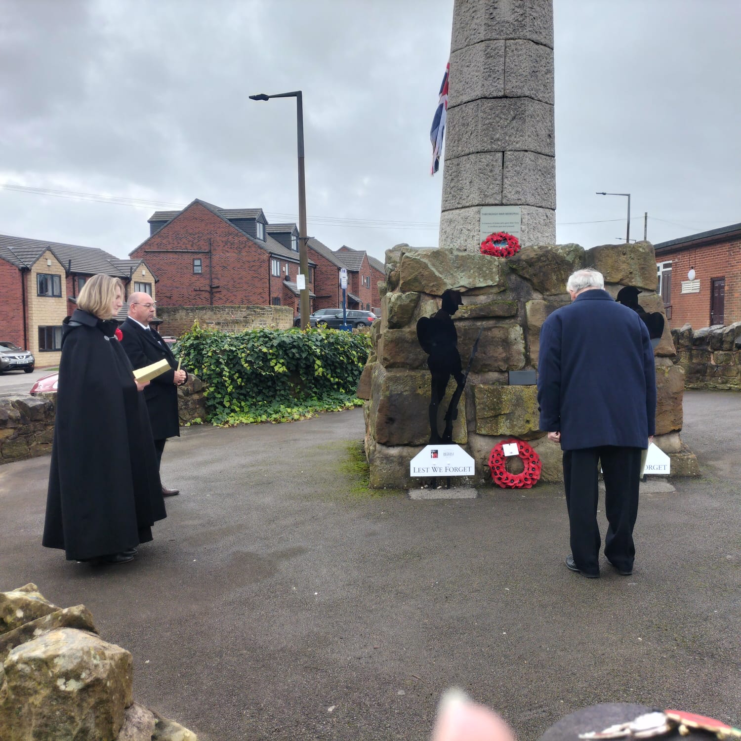 Public paying respects at war memorial.