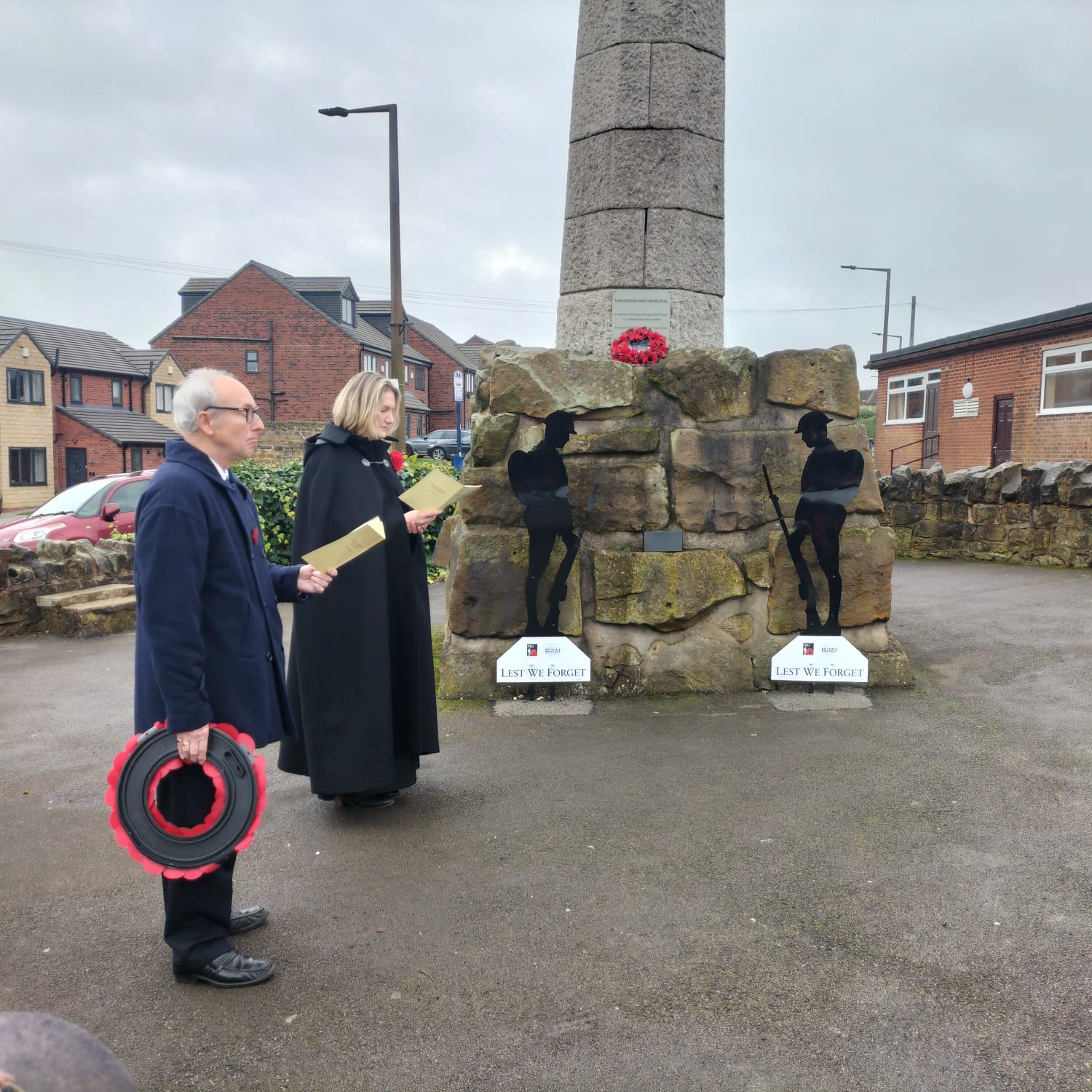 Public paying respects at war memorial.